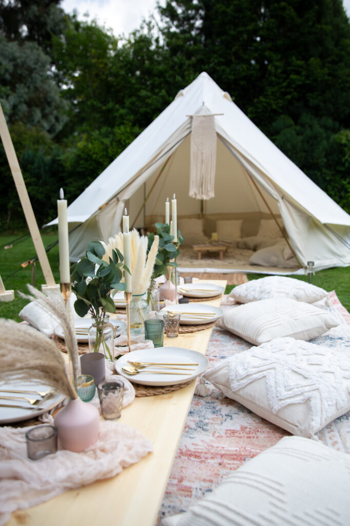 outdoor boho picnic table and luxury garden cinema bell tent